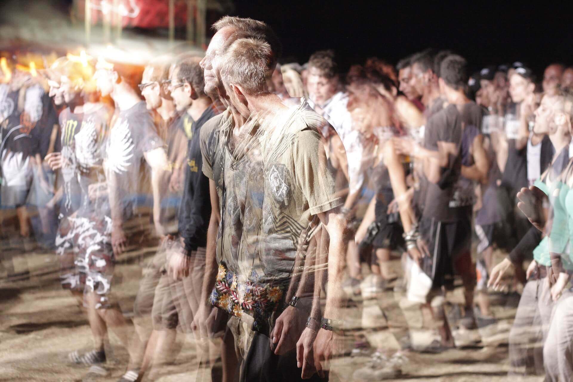 A blurry photograph of young people walking at night.